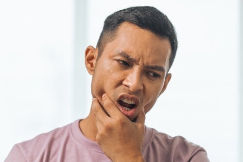 Man holding his jaw in pain