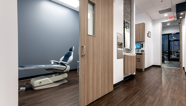 Hallway and dental treatment room in Pecan Grove dental office