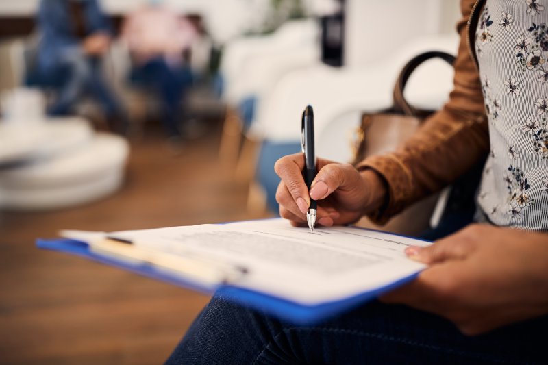 person filling out paperwork 